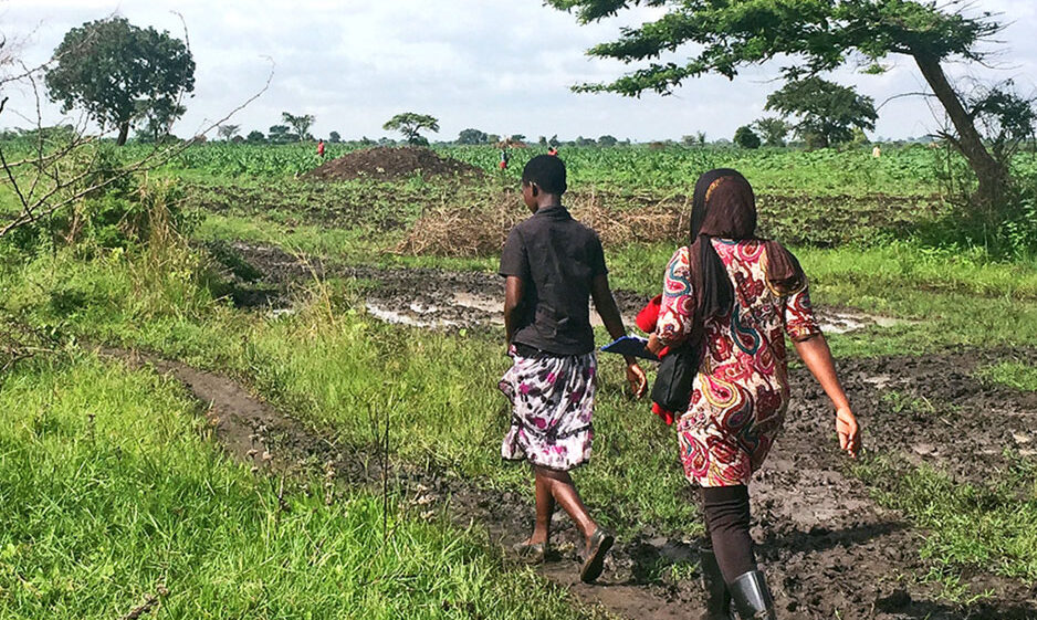 Two people walking in a field