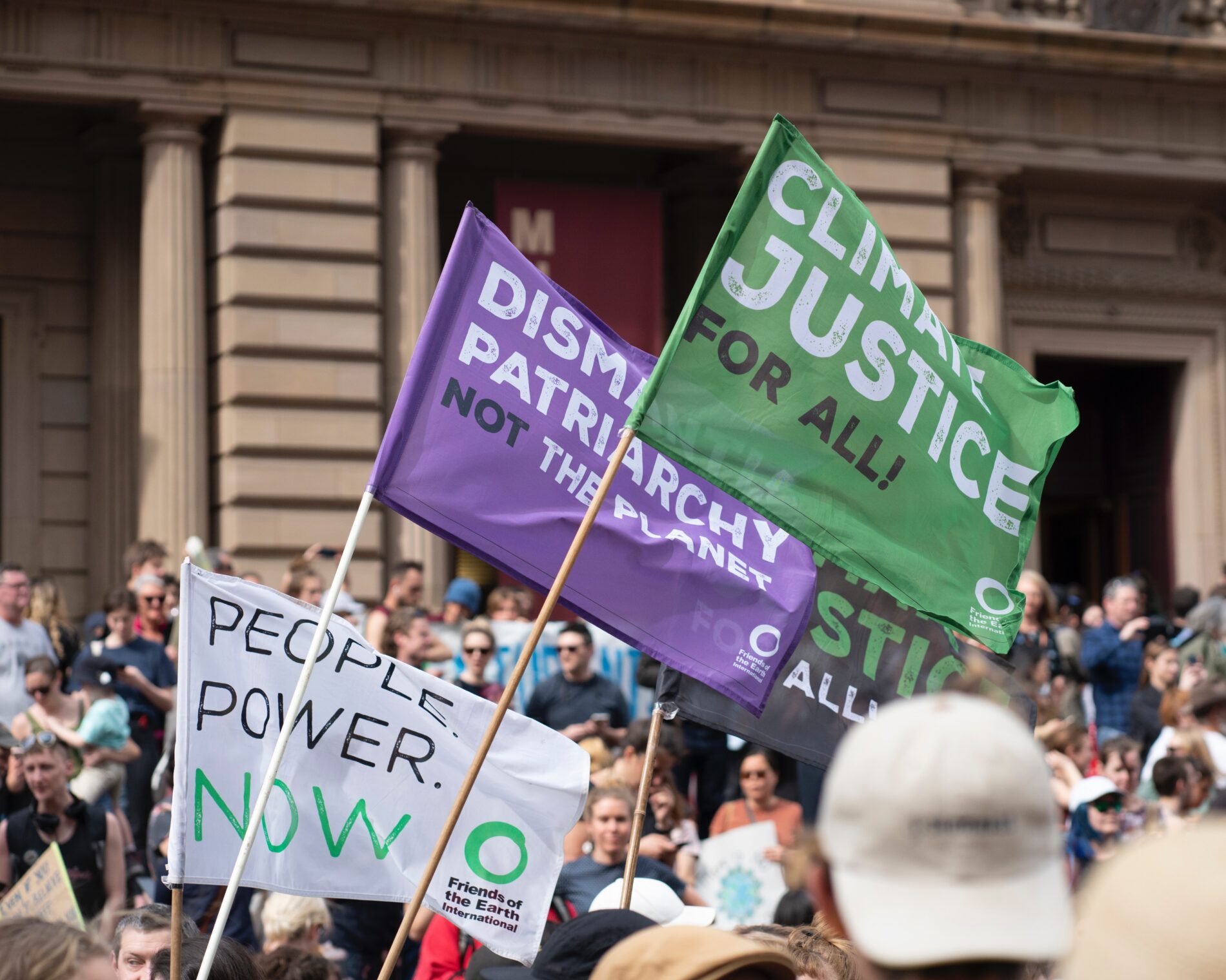 Climate justice for all flags at the Climate Strike Melbourne, Friend of the Earth International