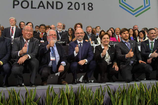 Officials cheer while seated