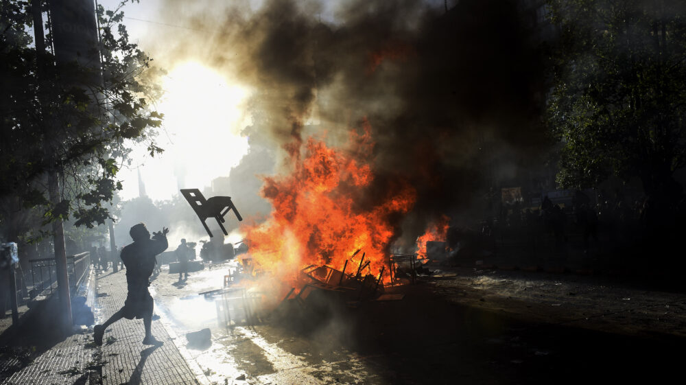 protester throws a chair in Santiago de Chile