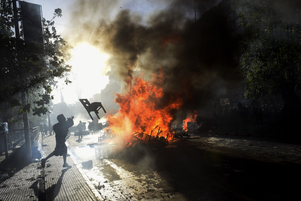 protester throws a chair in Santiago de Chile