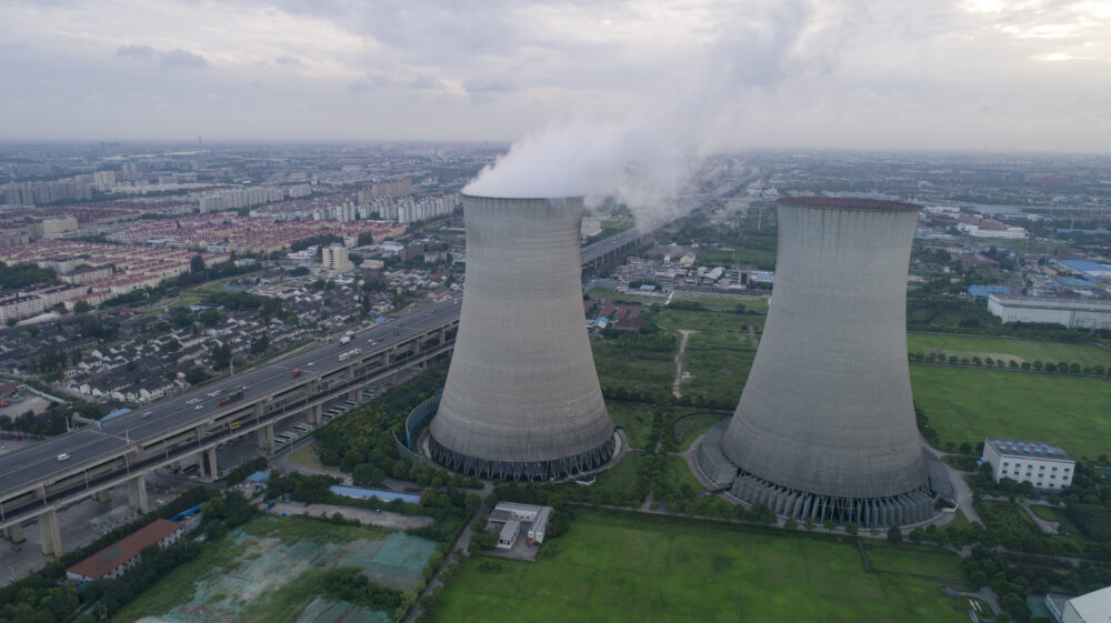 Smoking cooling towers of Shanghai Wujing coal power plant in the sunset