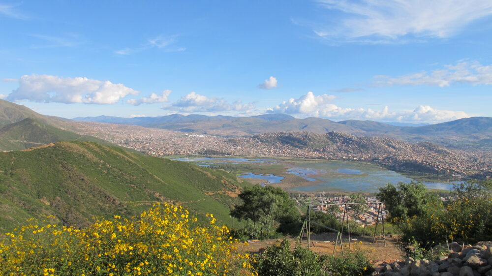 landscape of mountains, lake, town