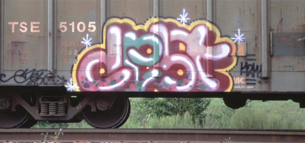 Side of cargo train with graffiti
