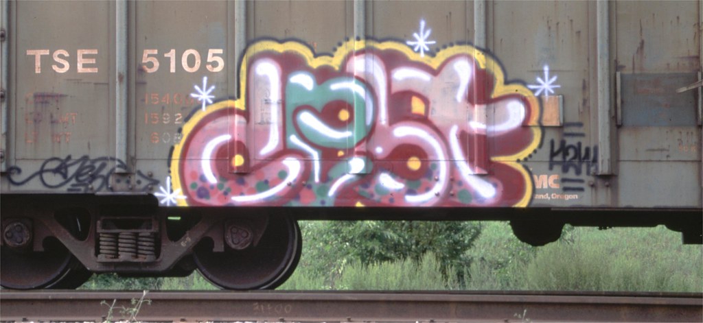 Side of cargo train with graffiti