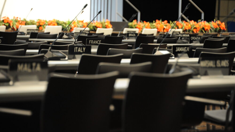Empty seats in a plenary room during a UN climate change conference