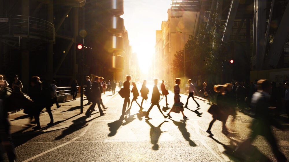 Business people walking through at city at dawn.