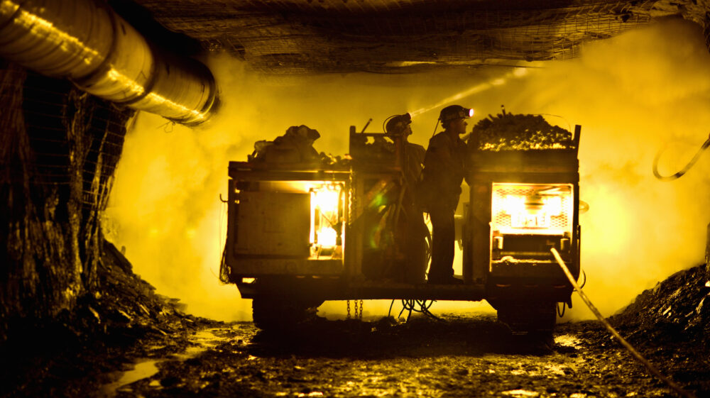 Two coal miners in mine shaft