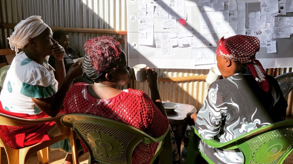 Workshop participants discuss the road map over a cup of tea, Kitulu Village, Kenya