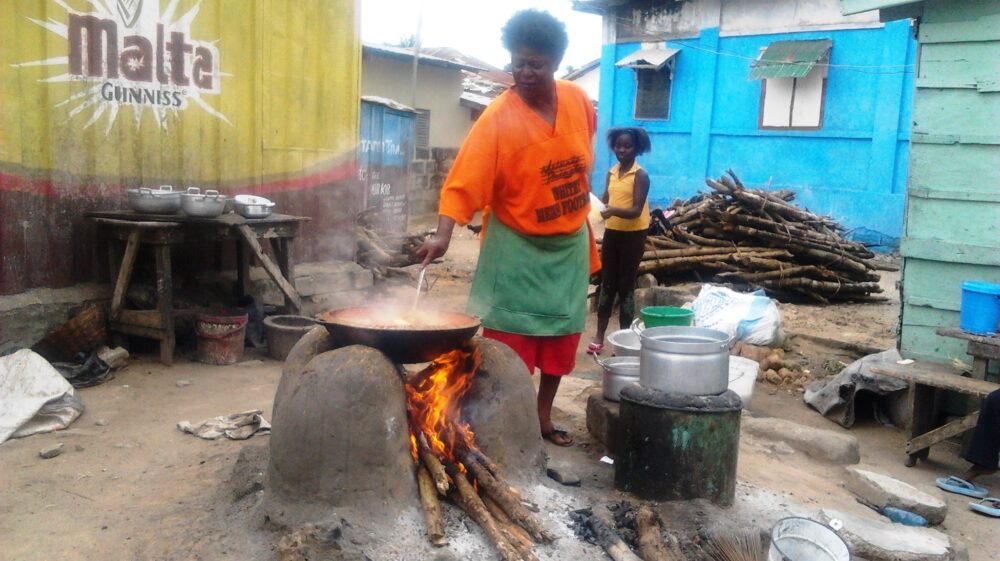 Woman cooking on a mud stove.