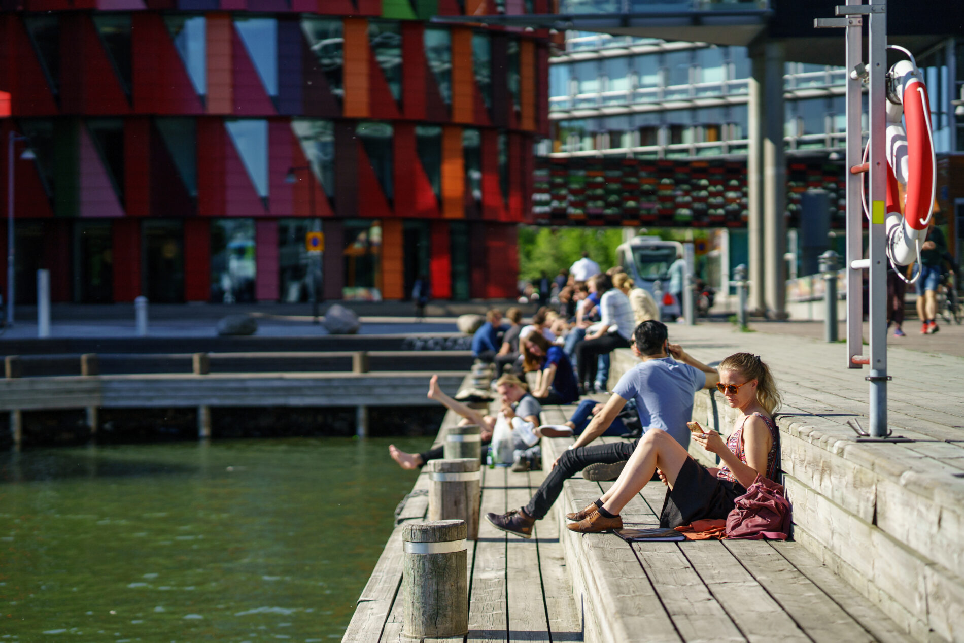 People enjoying the sunshine in Lindholmen Ferry Port