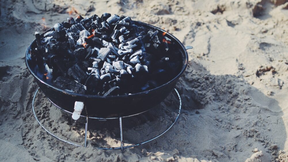 Image shows a smoldering charcoal basin.
