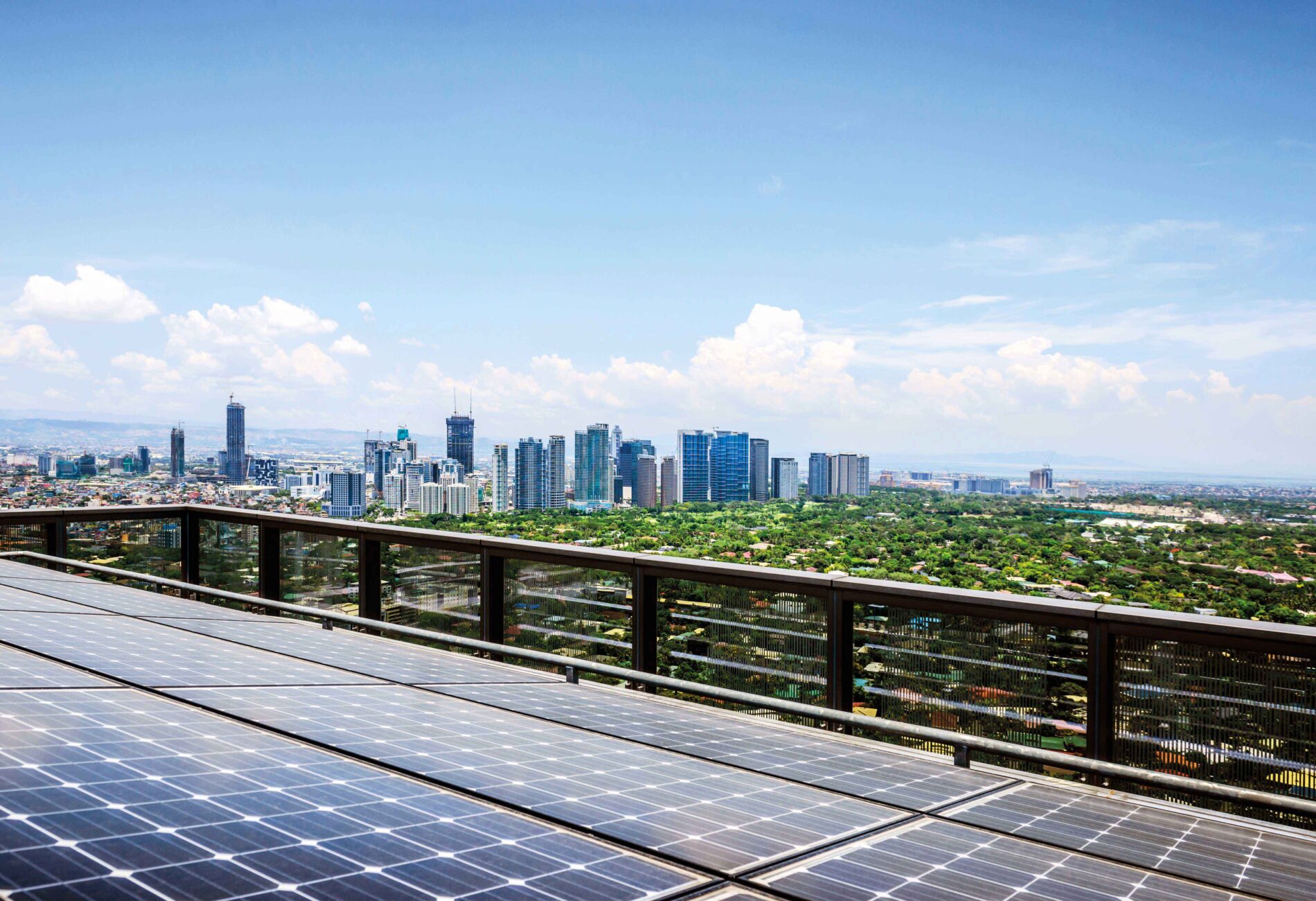 Solar roof panels and a cityscape in the background.