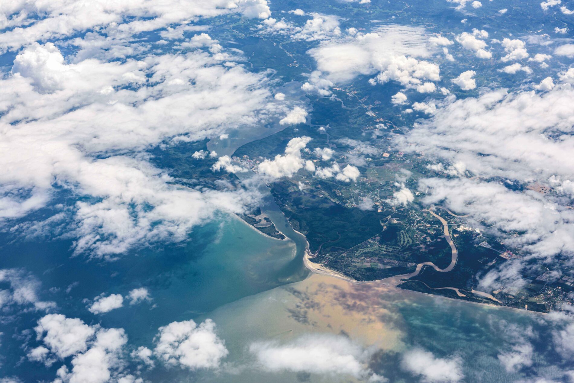 Aerial view of a delta, overlaid by clouds.