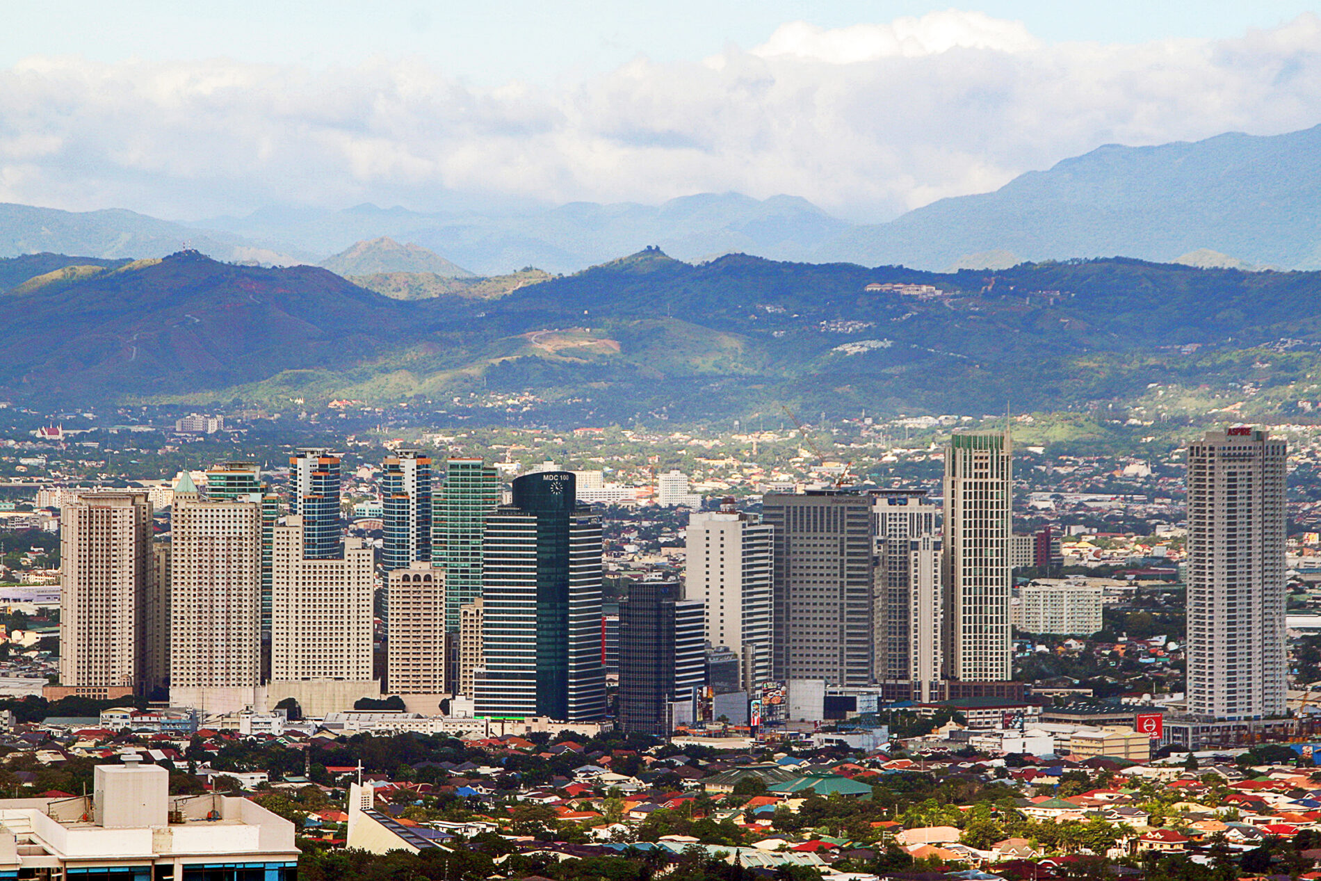 Skyscrapers of Metro Manila with the Sierra Madre mountain range in the background.