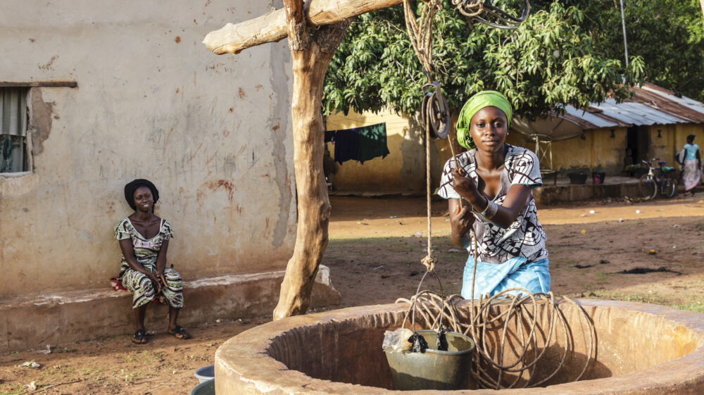 Two African women extracting water of a well in Ziguinchor, Senegal