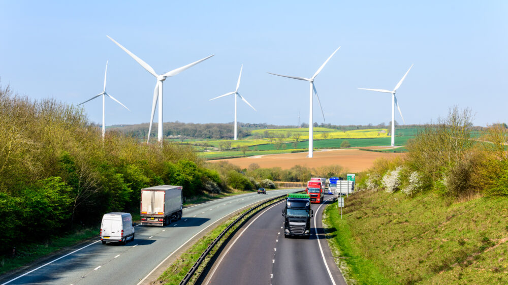 Day view UK motorway road wind turbines