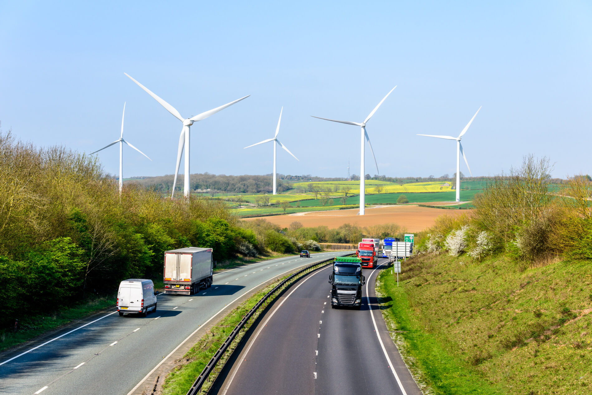 Day view UK motorway road wind turbines