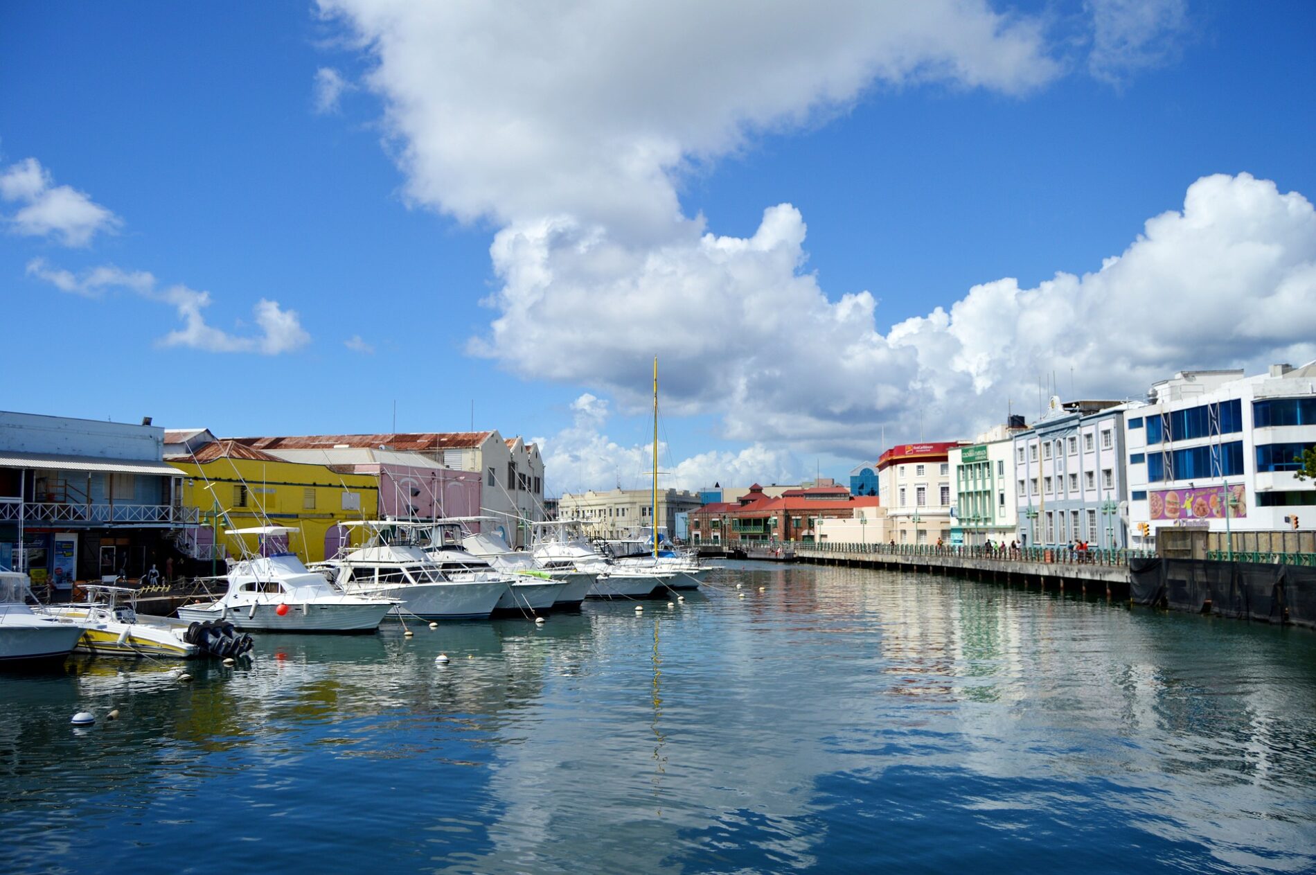 Boats docked on boardwalk-lined Constitution River in Bridgetown, Barbados