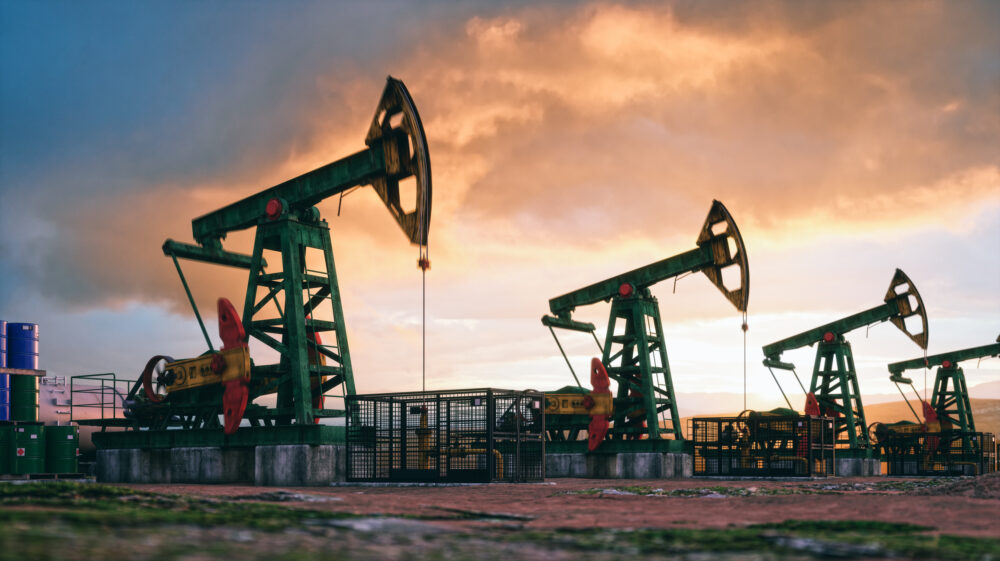 Working oil pumps against a sunset sky