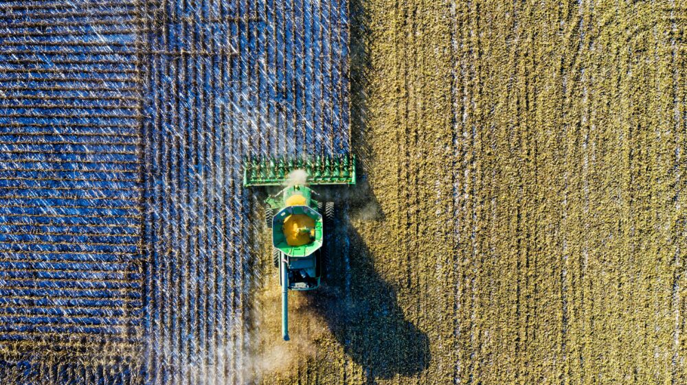 Aerial shot of green milling tractor in field, Austin, Texas