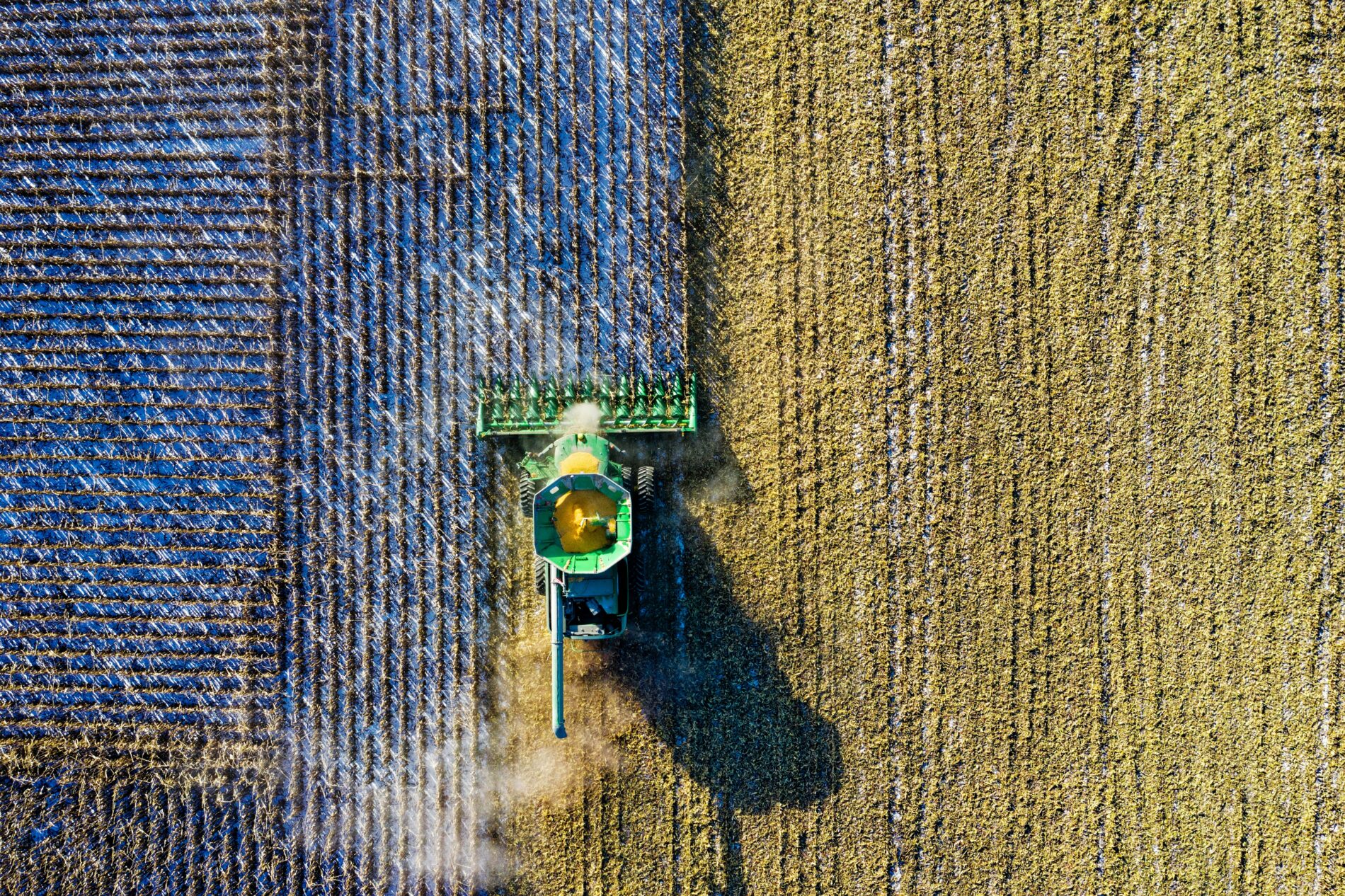 Aerial shot of green milling tractor in field, Austin, Texas