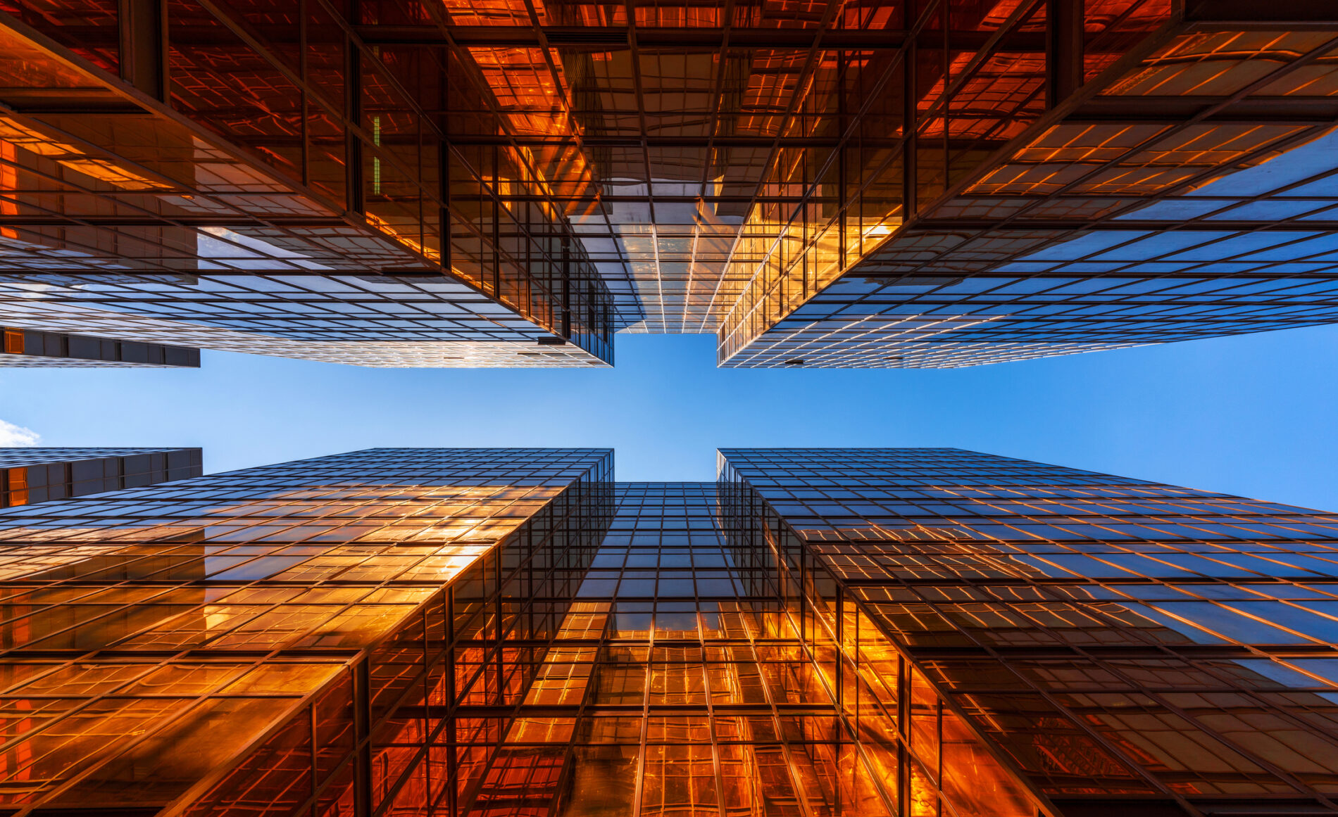 Golden building with blue sky. Windows glass of modern office skyscrapers. facade design. Architecture exterior for cityscape background