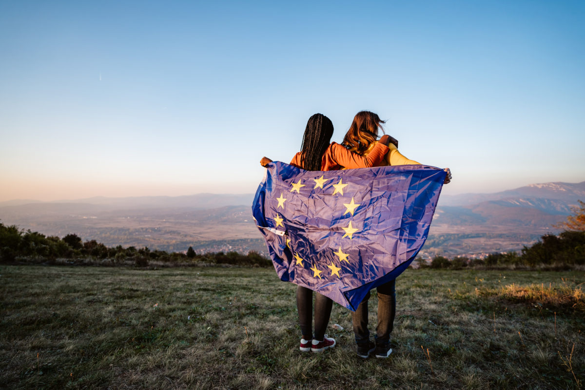 Two young women holding EU flag, Serbia