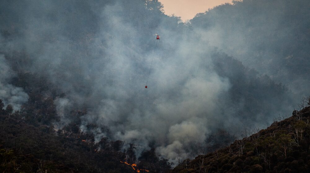 Helicopter attempts to put out mountain bushfire in Fingal, Tasmania, 2020