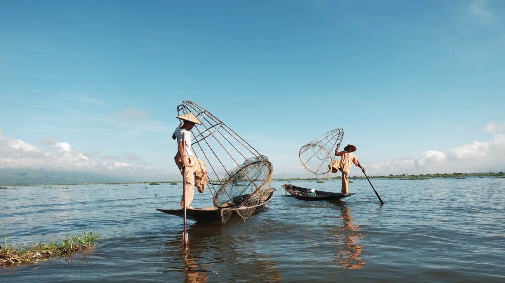 Two men using traditional fishing nets, Inle Lake, Myanmar