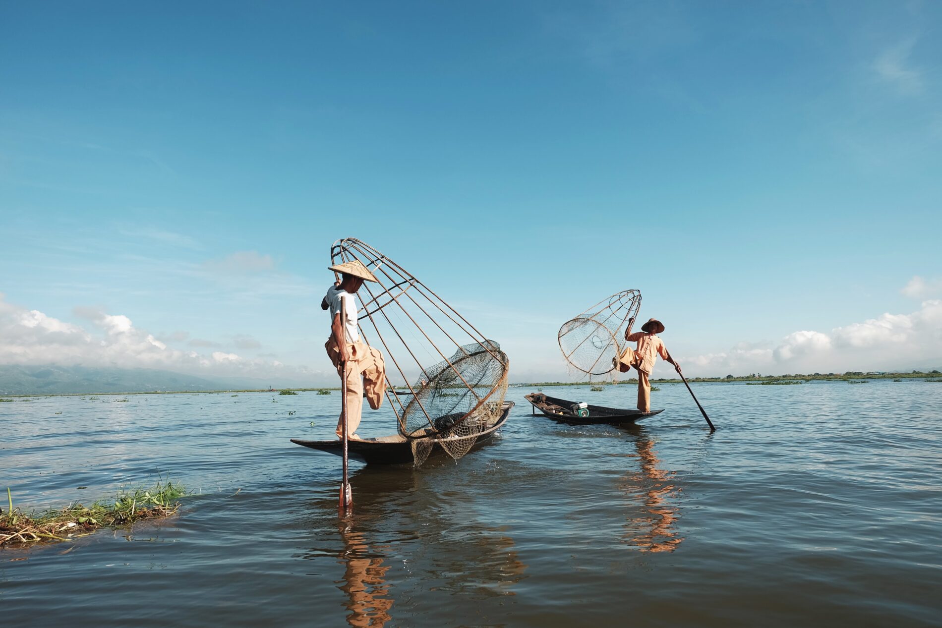 Two men using traditional fishing nets, Inle Lake, Myanmar