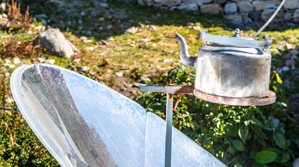 Solar cooker uses sun's energy to boil a kettle of water in Nepal