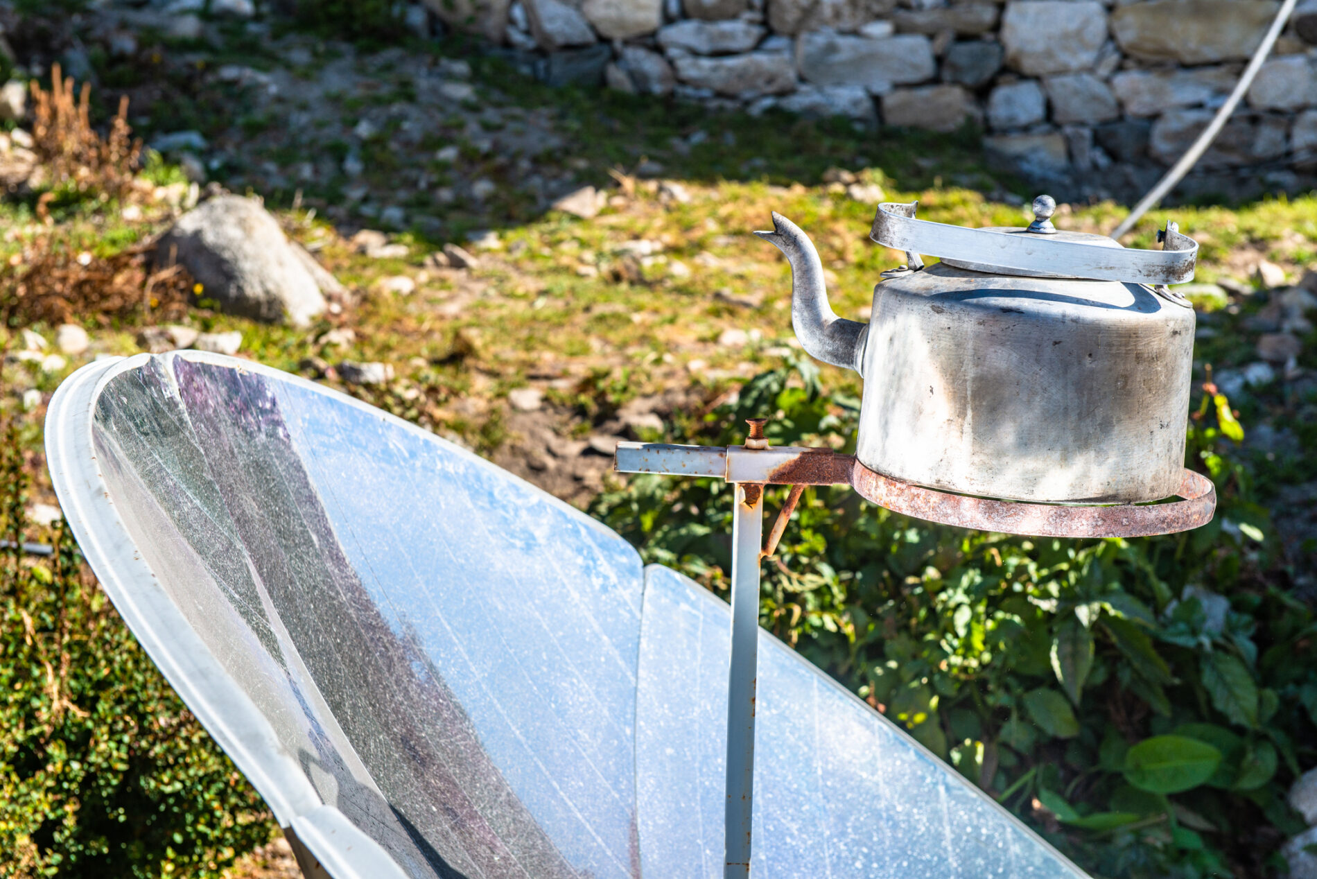 Solar cooker uses sun's energy to boil a kettle of water in Nepal