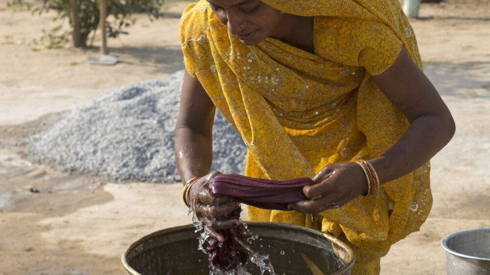 Woman washing clothes by hand, Agra, Uttar Pradesh, India