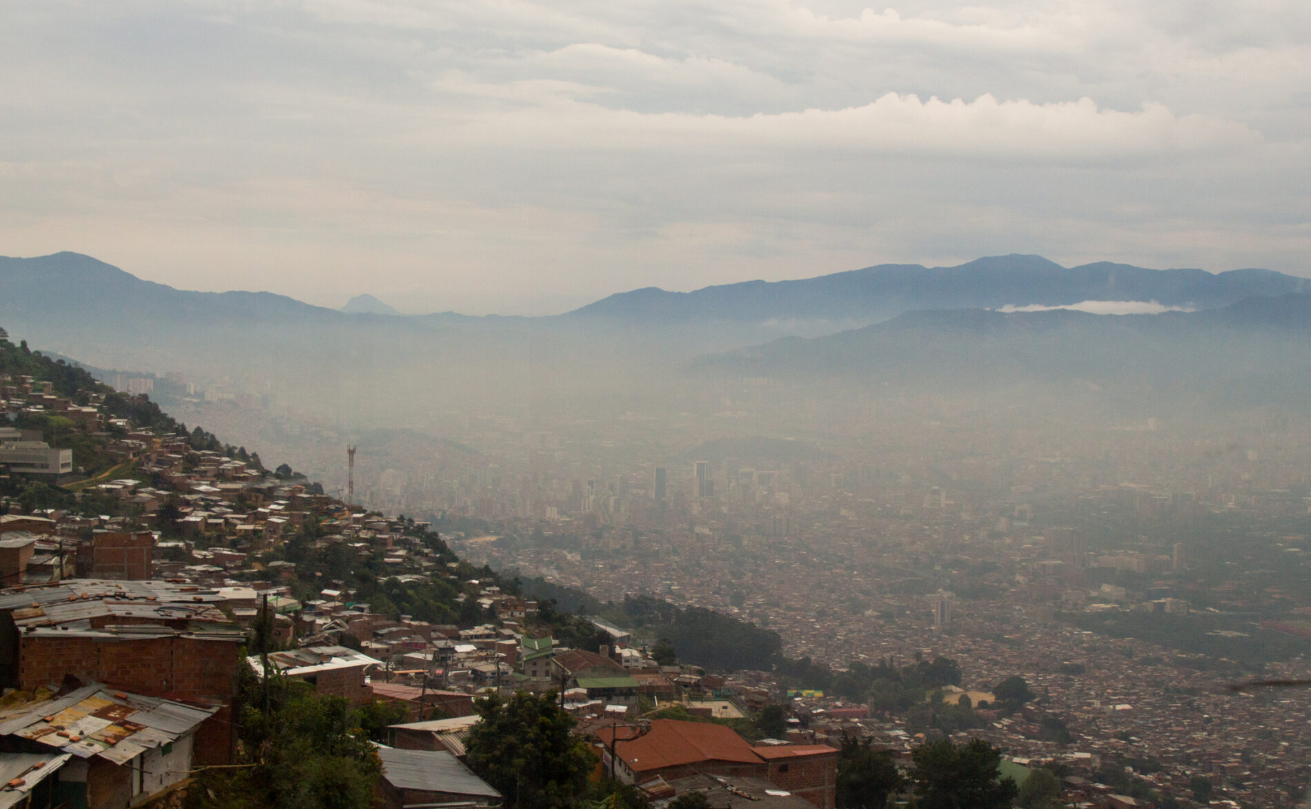 View over Medellín, Colombia, located in a valley between mountains, smog over downtown area