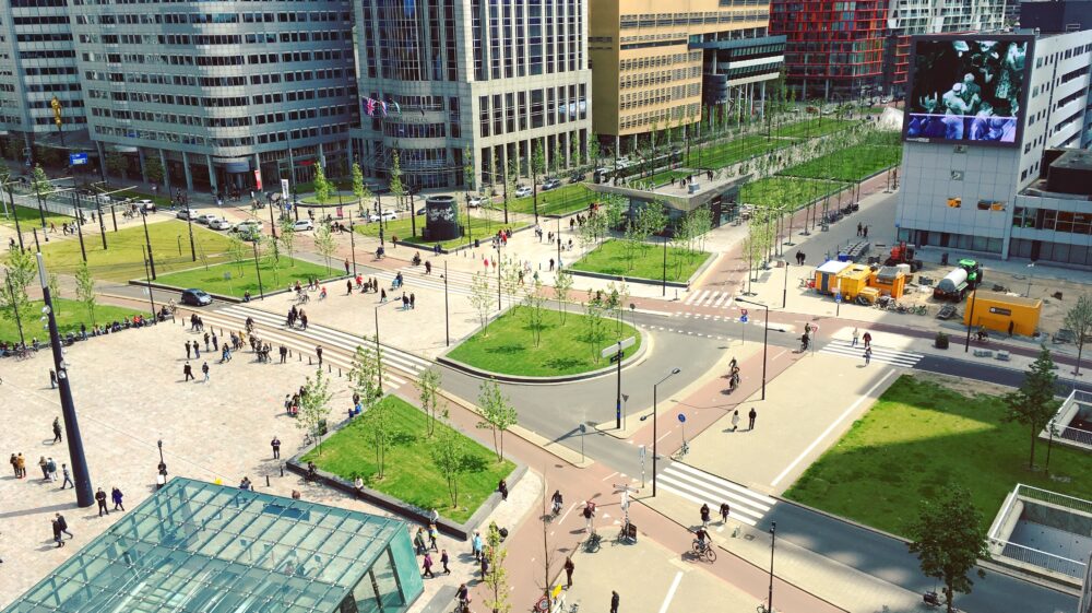 Outdoor aerial view of square outside Rotterdam Centraal Station on sunny day with Union Jack flying above, Rotterdam, Netherlands