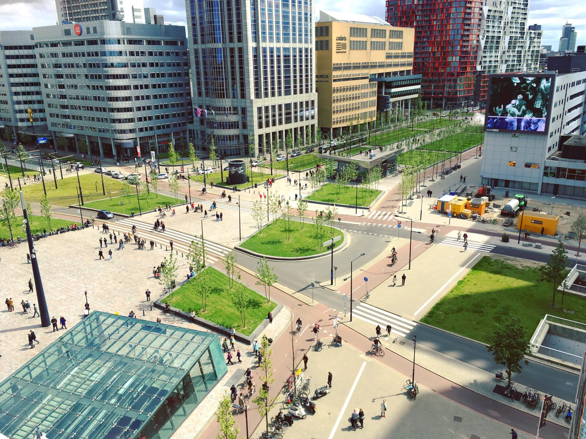 Outdoor aerial view of square outside Rotterdam Centraal Station on sunny day with Union Jack flying above, Rotterdam, Netherlands