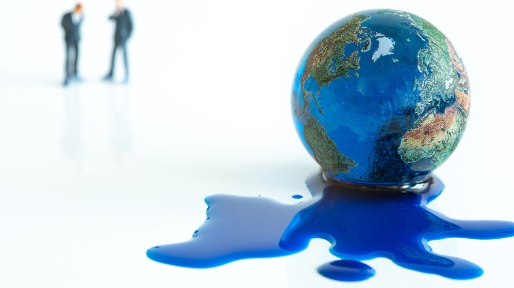 Blue water leaking from melting earth illustration with two blurry men in background.