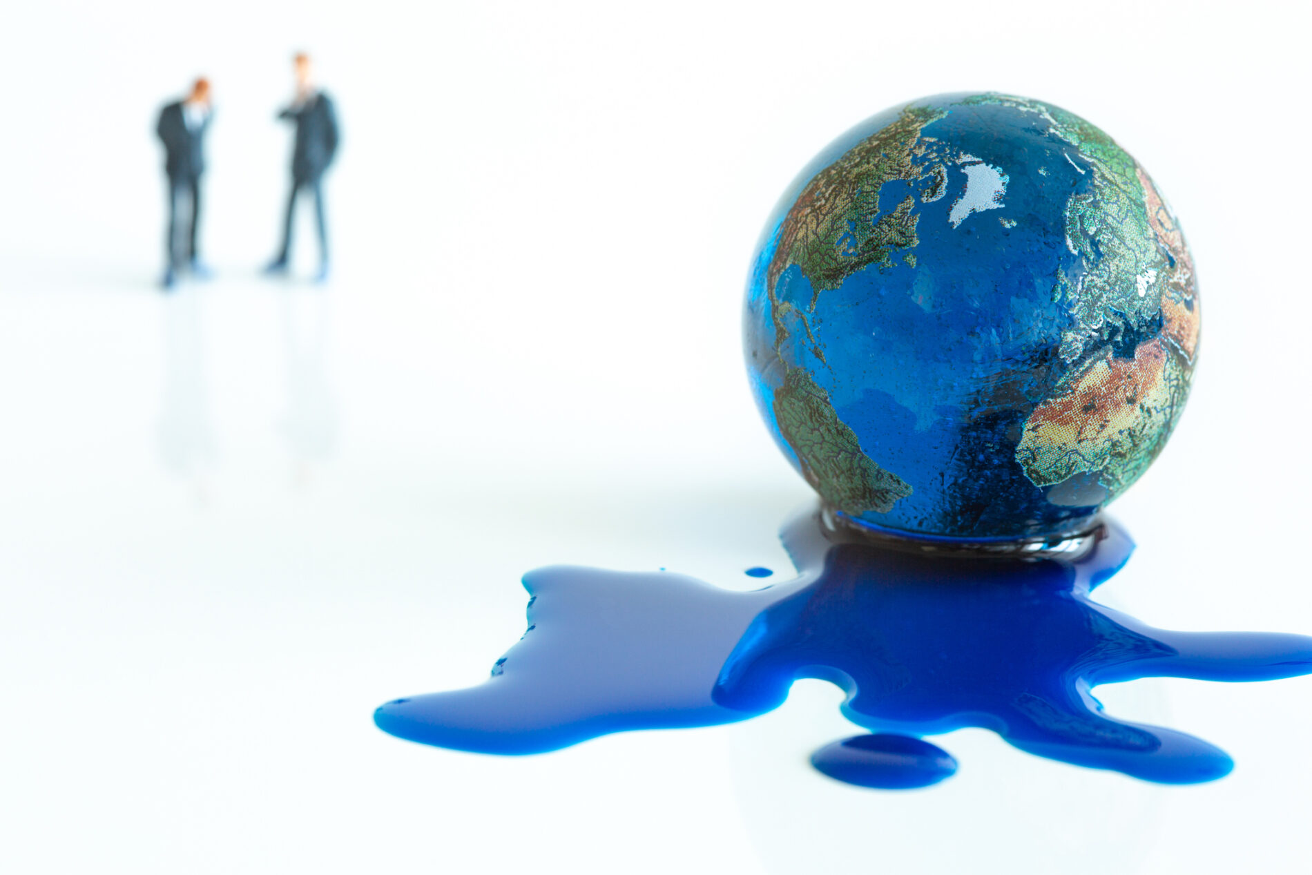 Blue water leaking from melting earth illustration with two blurry men in background.