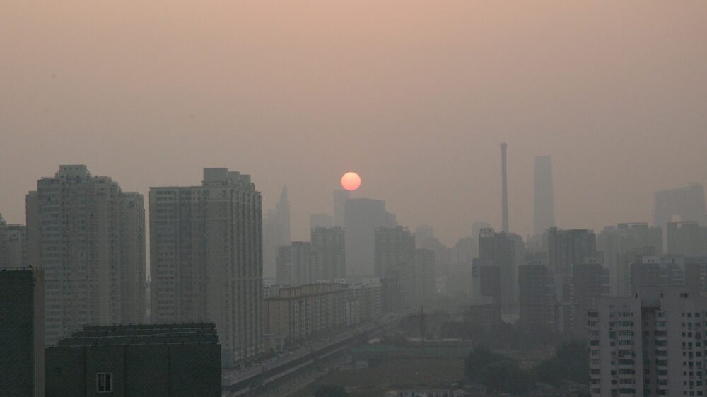 Sunset over smog on buildings, Beijing, China, 2009