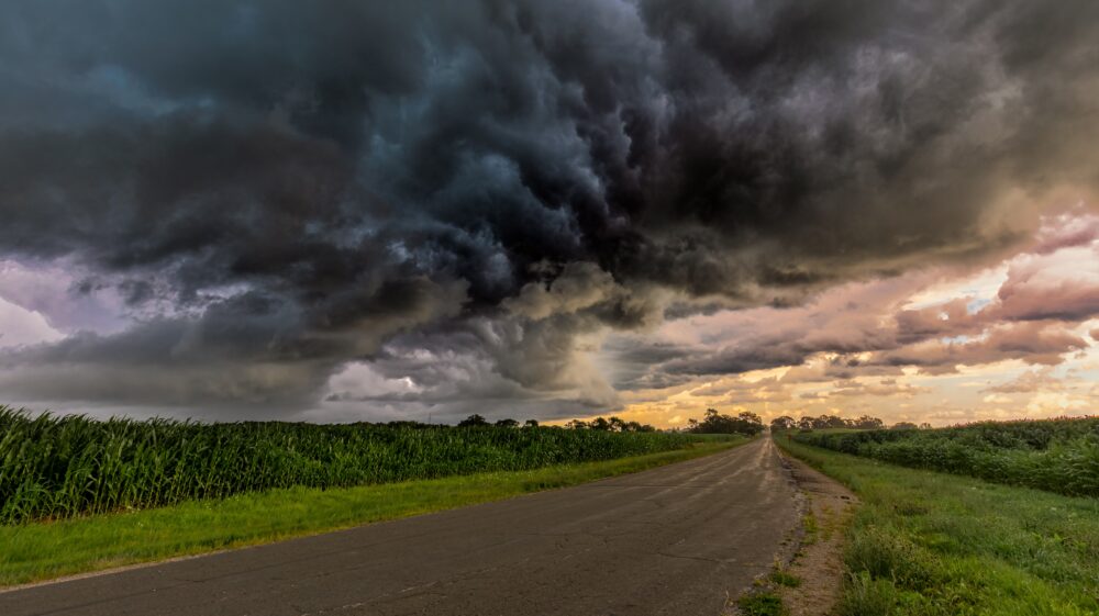 Storm clouds over road between cornfields, Sun Prairie, WI, 2020