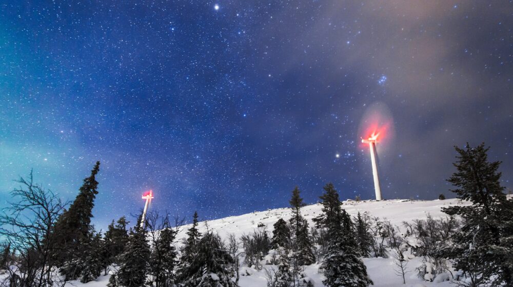 Wind generators sit atop hill under a starry sky north of Arctic Circle, Lapland Hotel Olos, Muonio, Finland