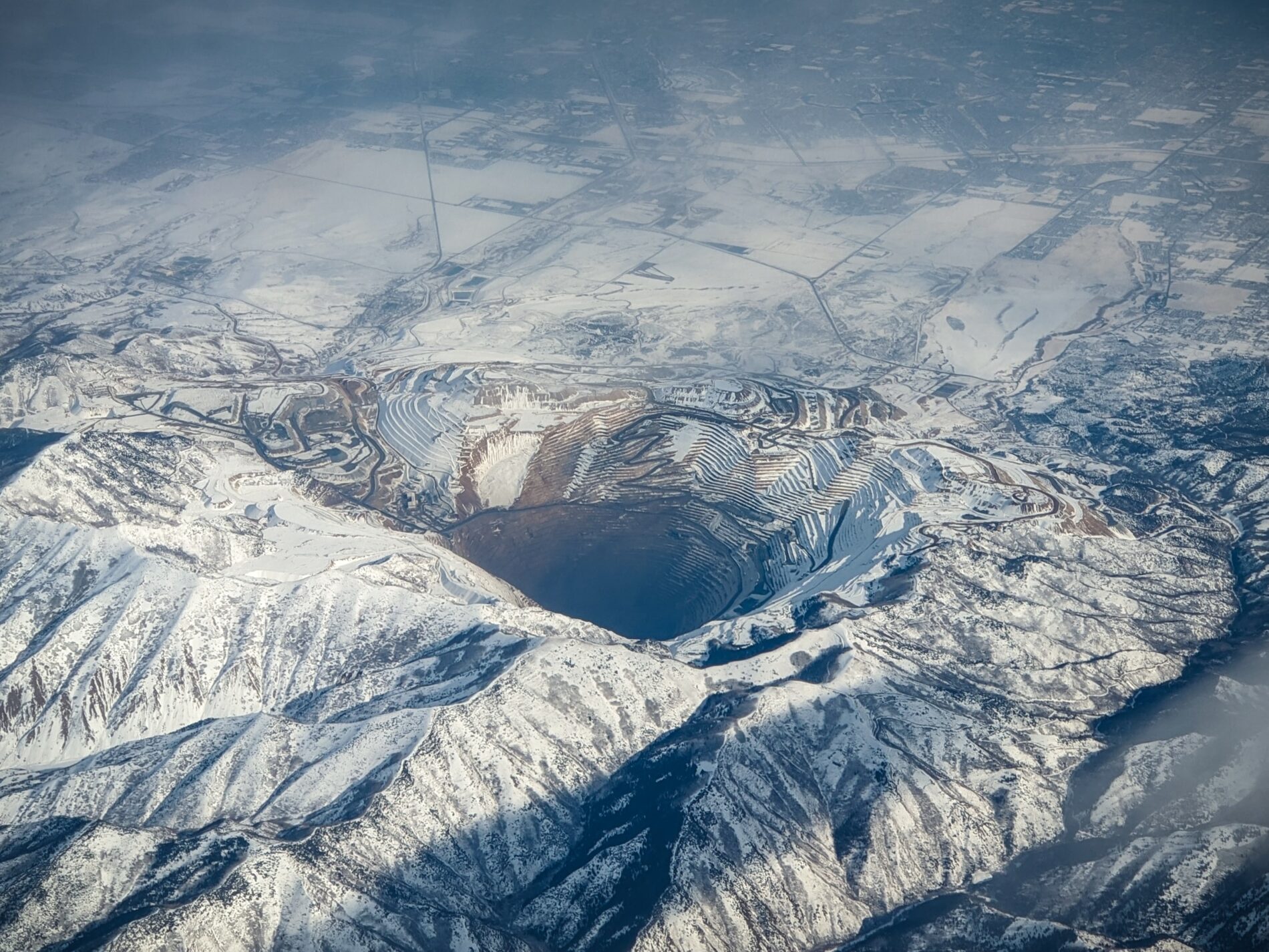 Aerial view of Bingham Copper Mine covered in snow, Utah, US, 2019