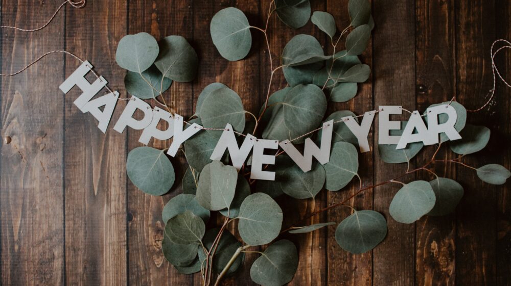 Happy New Year strand laying over eucalyptus branch