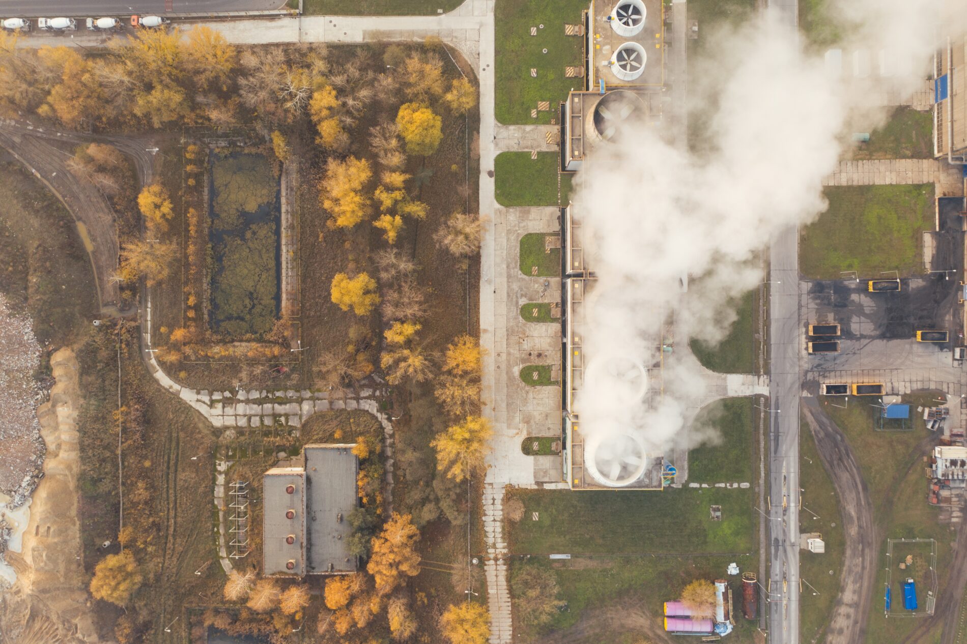 Aerial view of industrial chimneys with billowing smoke
