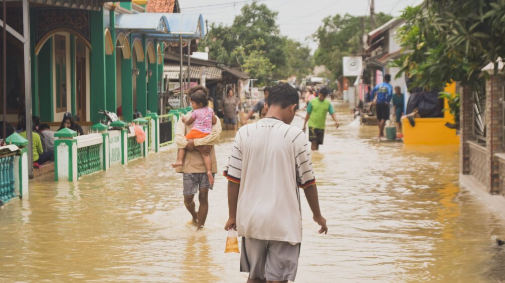 People walking on flooded street, Indonesia, April 2021