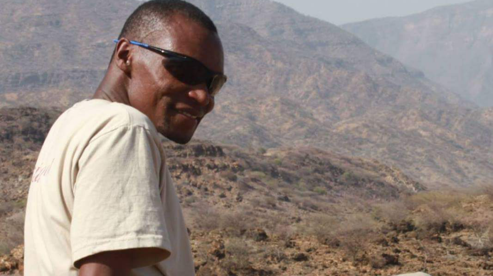 SEI's Lawrence Nzuve prospecting for fossils on Lapur Range, northern Kenya