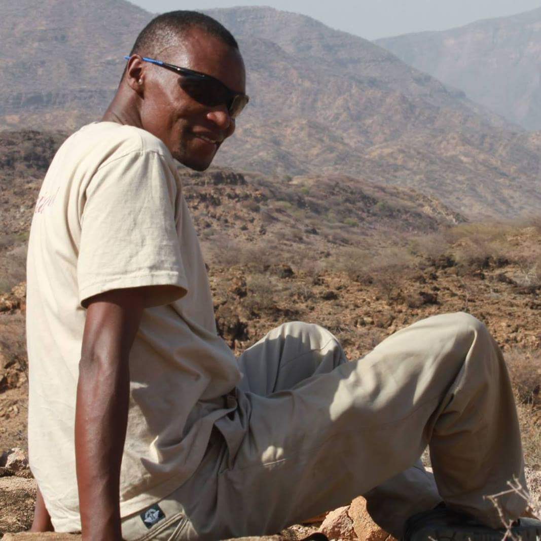 SEI's Lawrence Nzuve prospecting for fossils on Lapur Range, northern Kenya