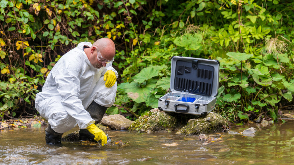 Scientist taking water samples from a river