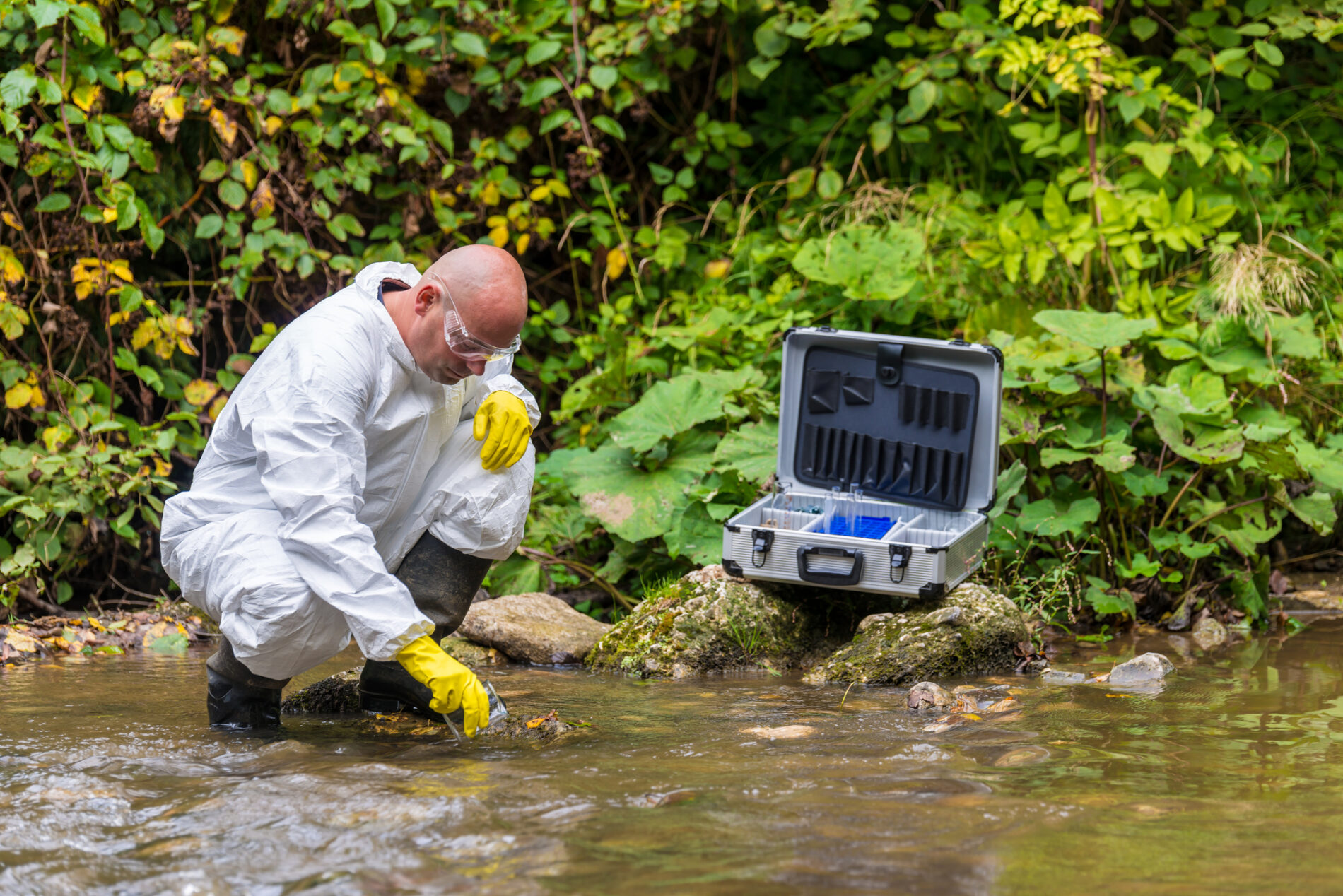 Scientist taking water samples from a river